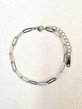 Sienna Paperclip Chain Silver Bracelet on a neutral background