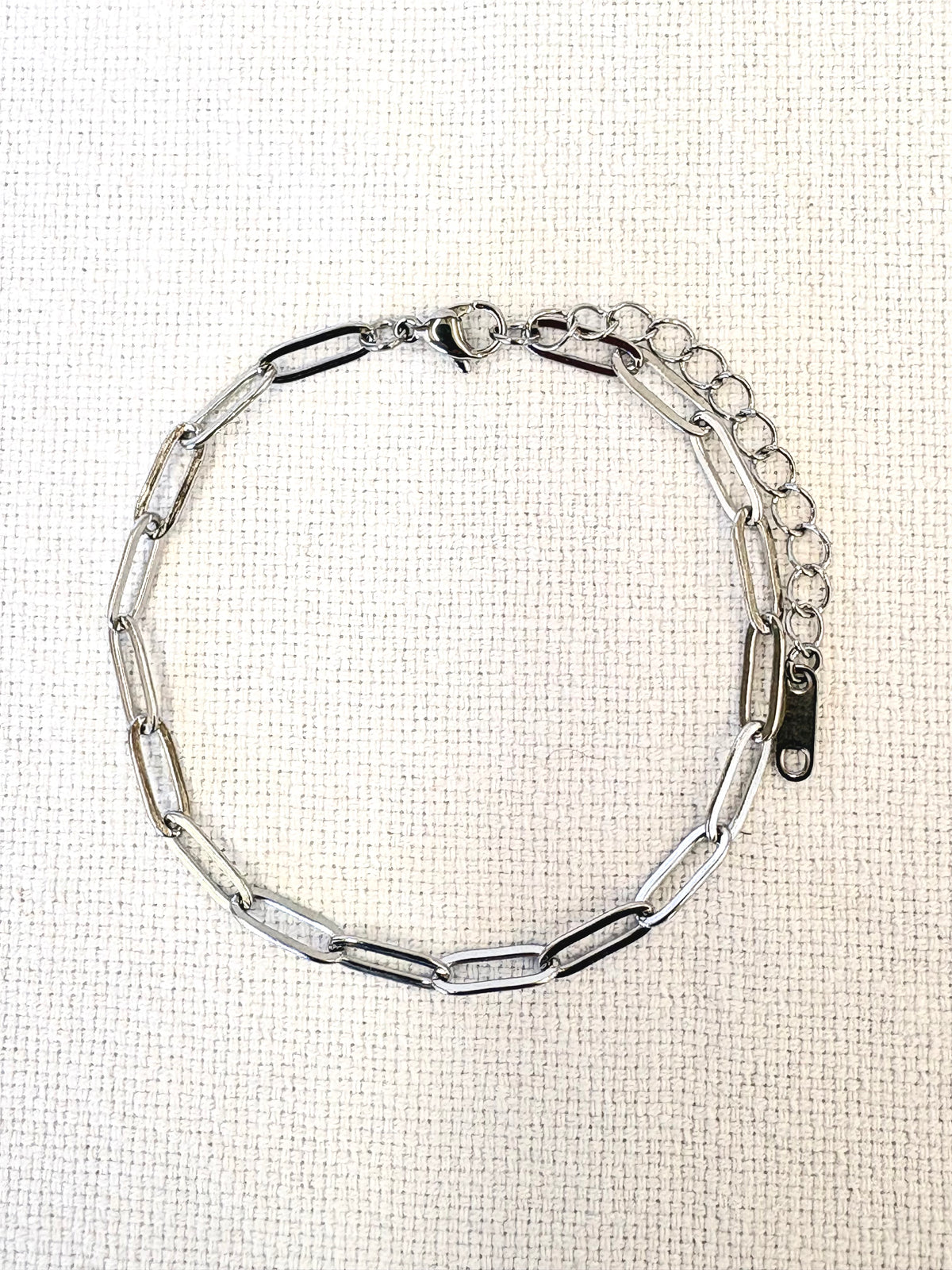 Sienna Paperclip Chain Silver Bracelet on a neutral background