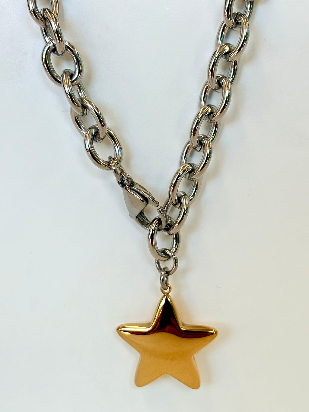 Necklace with a gold star pendant on a white background