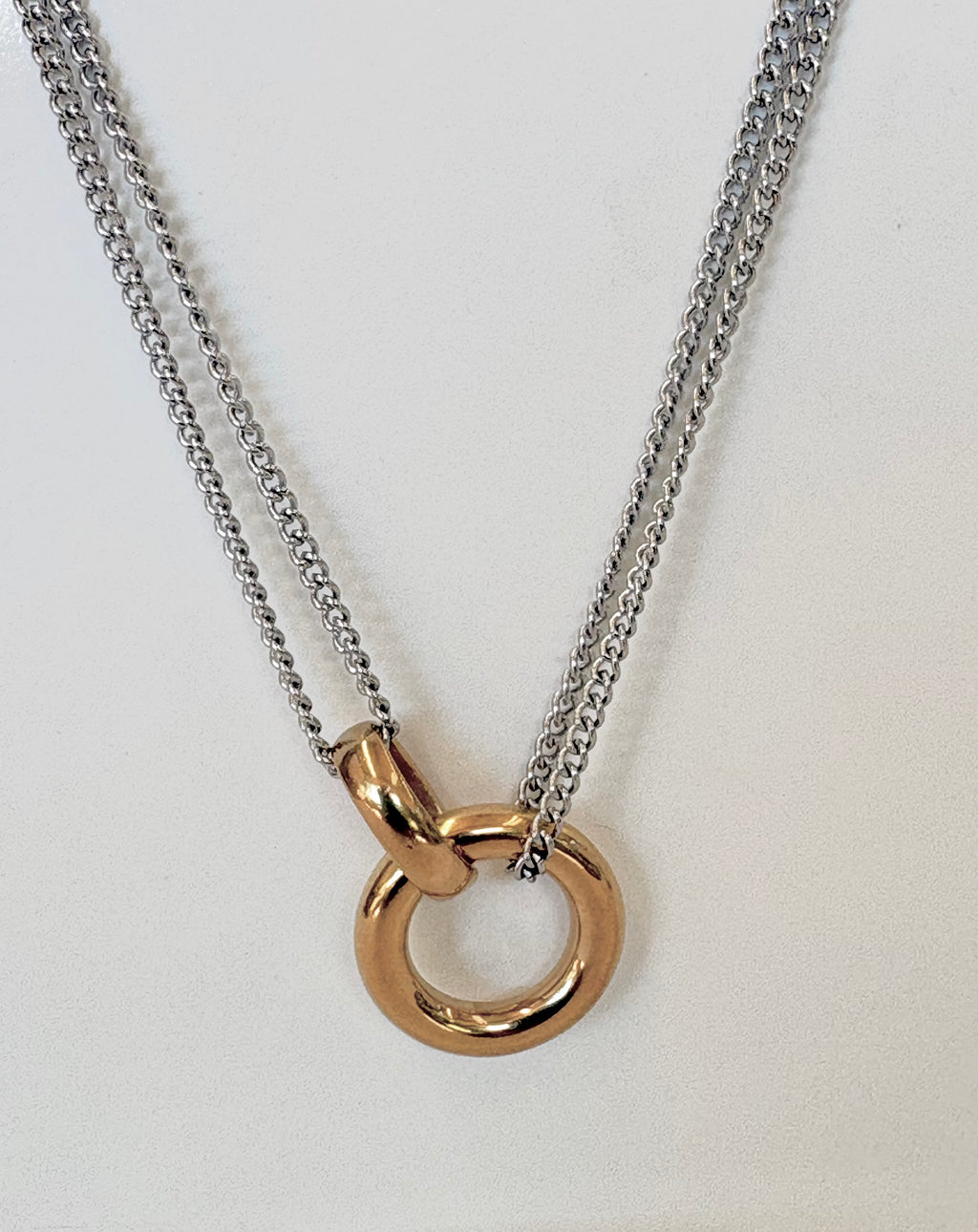 Necklace with a gold ring pendant on a white background