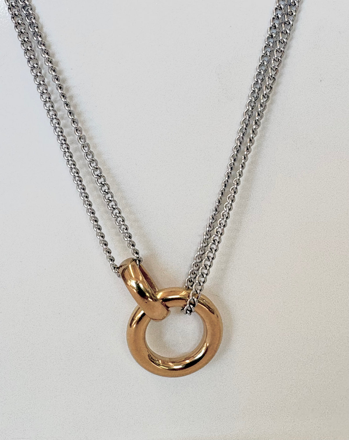 Necklace with a gold ring pendant on a white background