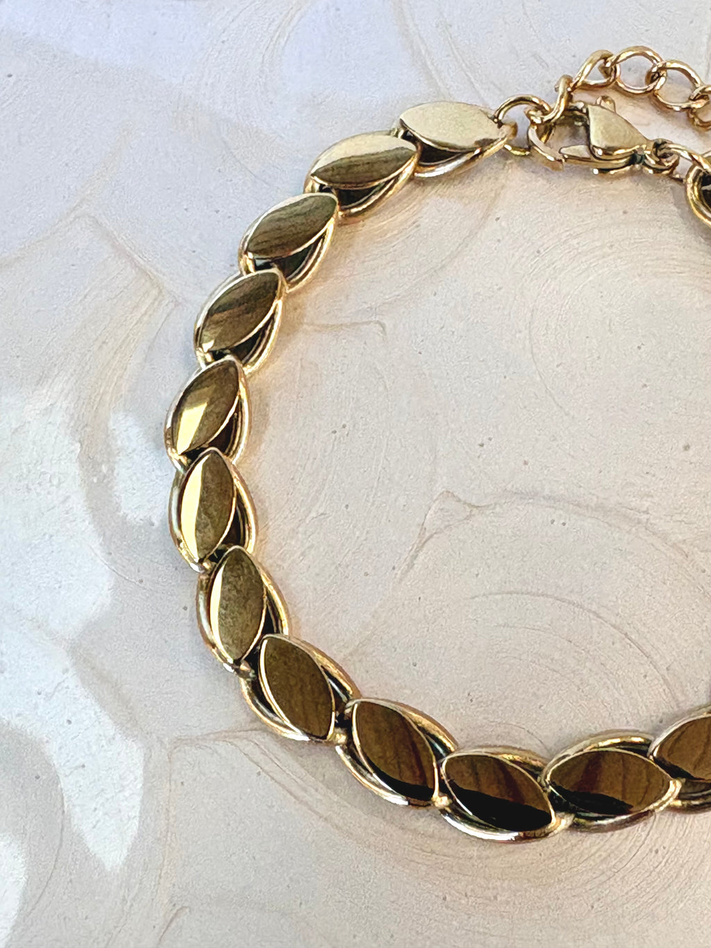 Lumi Gold Bracelet flat lay on neutral background