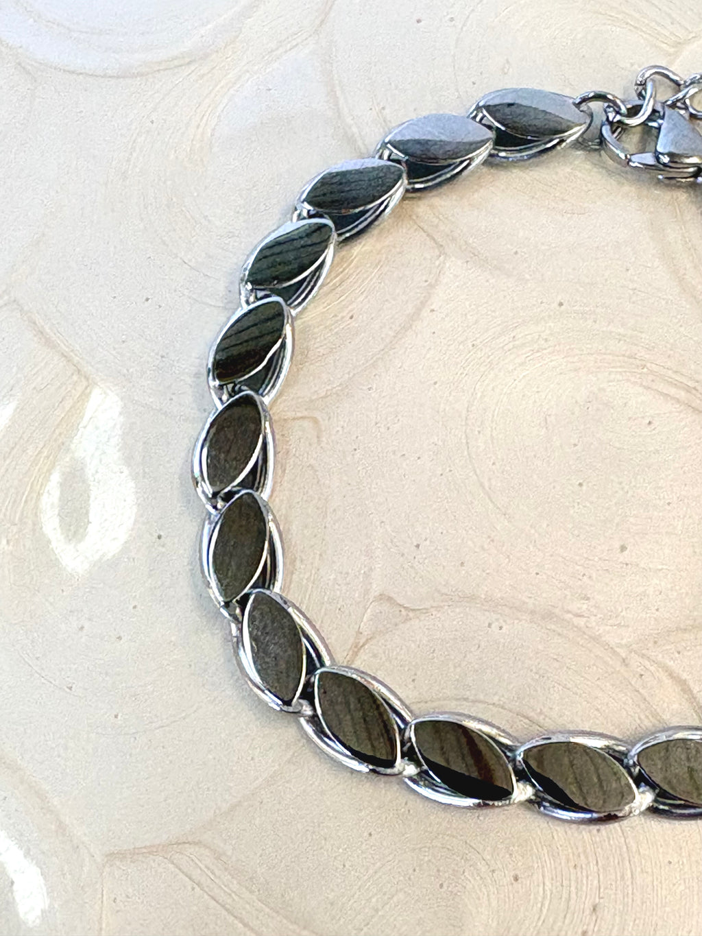 Lumi Silver Bracelet flat lay on neutral background