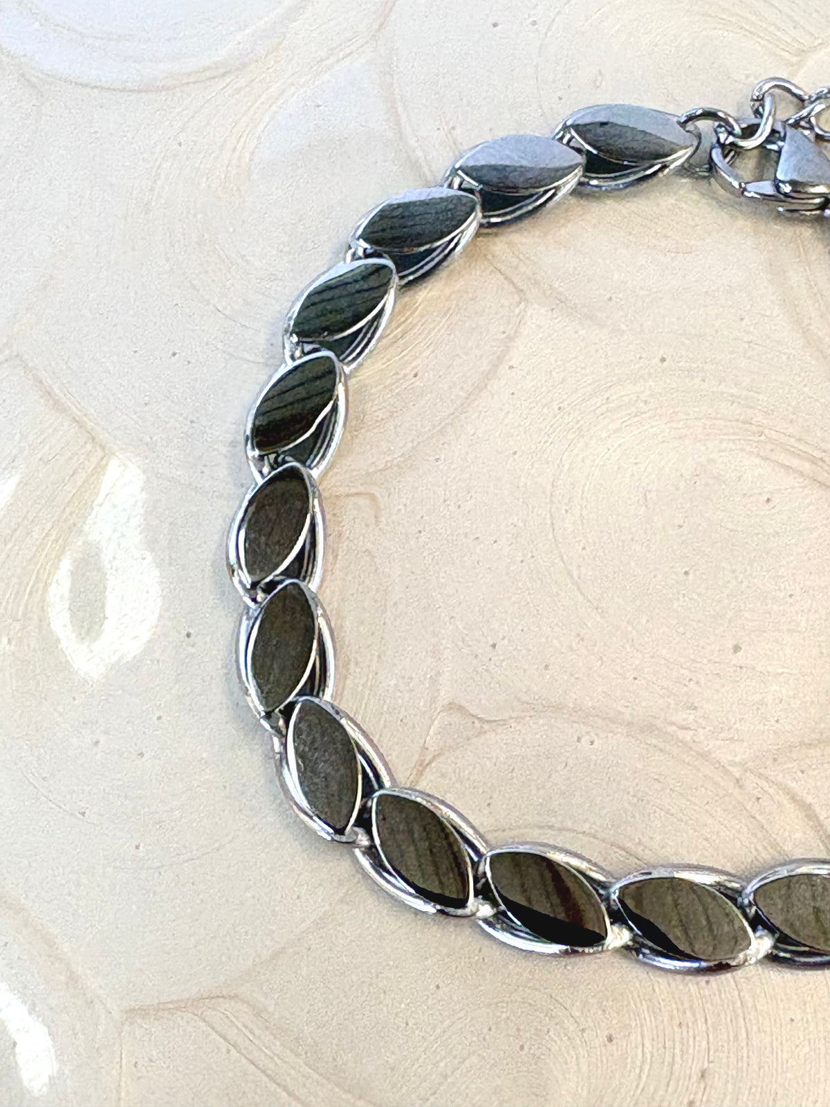 Lumi Silver Bracelet flat lay on neutral background