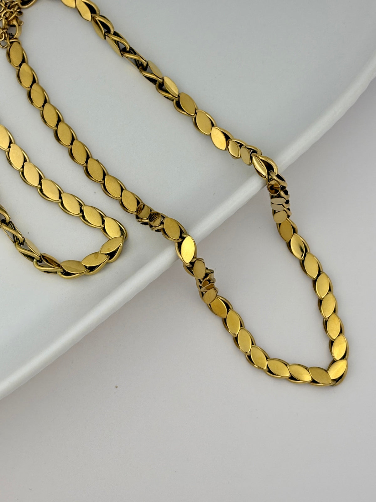 Gold chain necklace on a white background