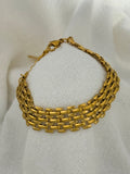 Mackenzie Gold Bracelet on a fabric background