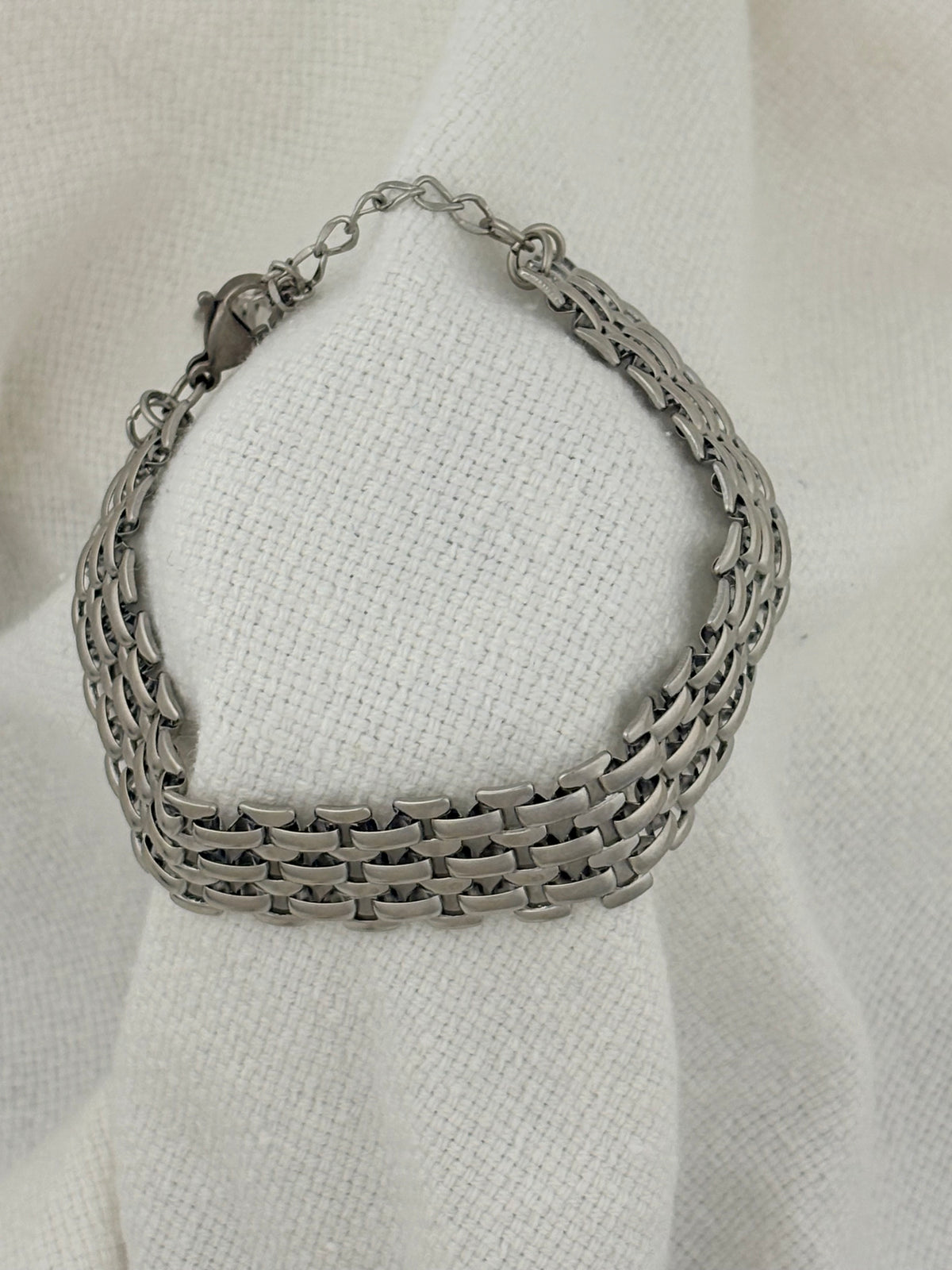 Mackenzie Silver Bracelet on a fabric background