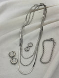 Silver jewellery on a light colour background