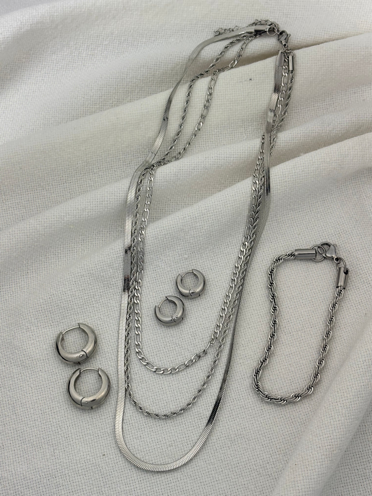 Silver jewellery on a light colour background