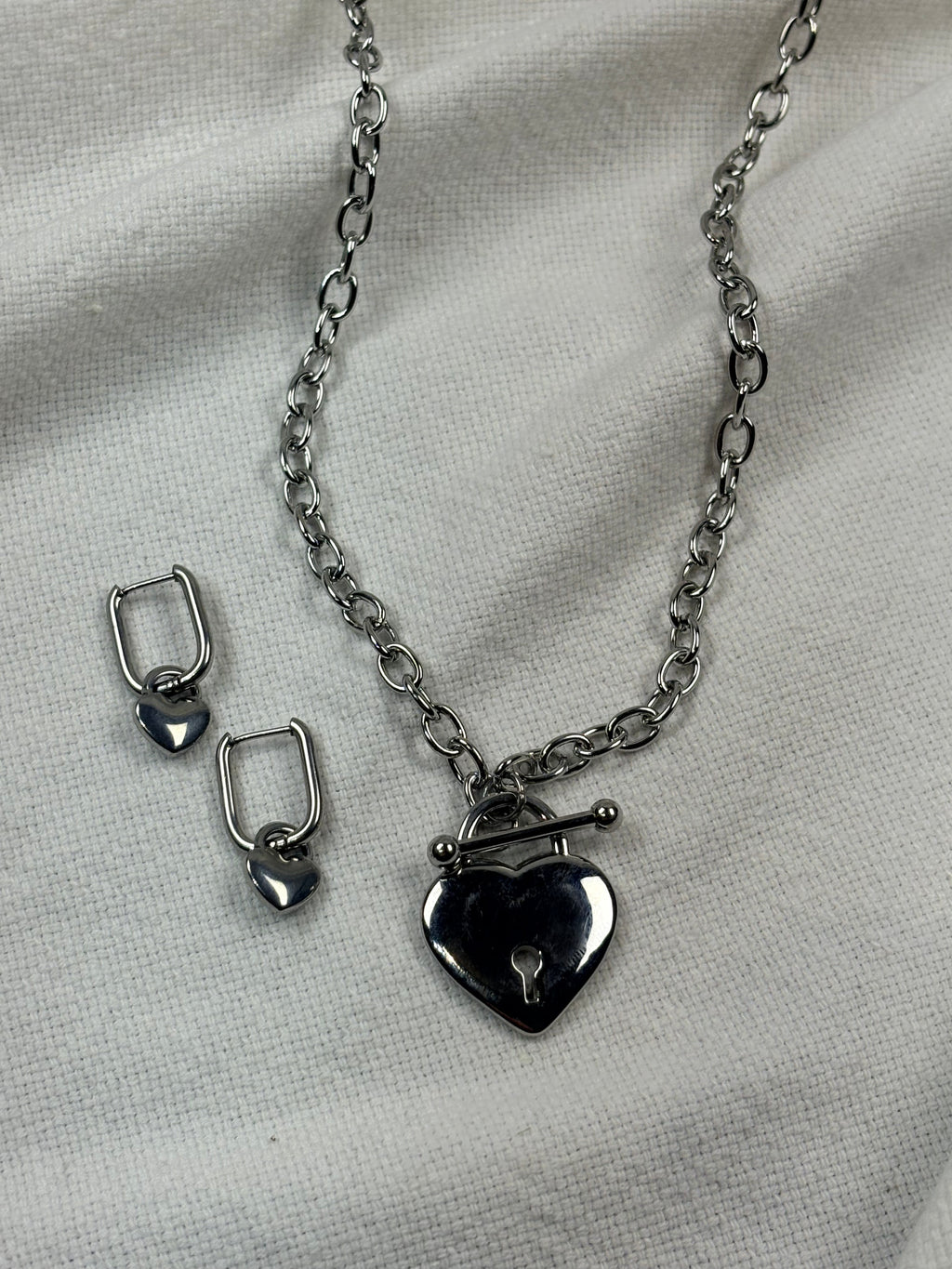 Silver necklace with heart pendant and heart hoop earrings