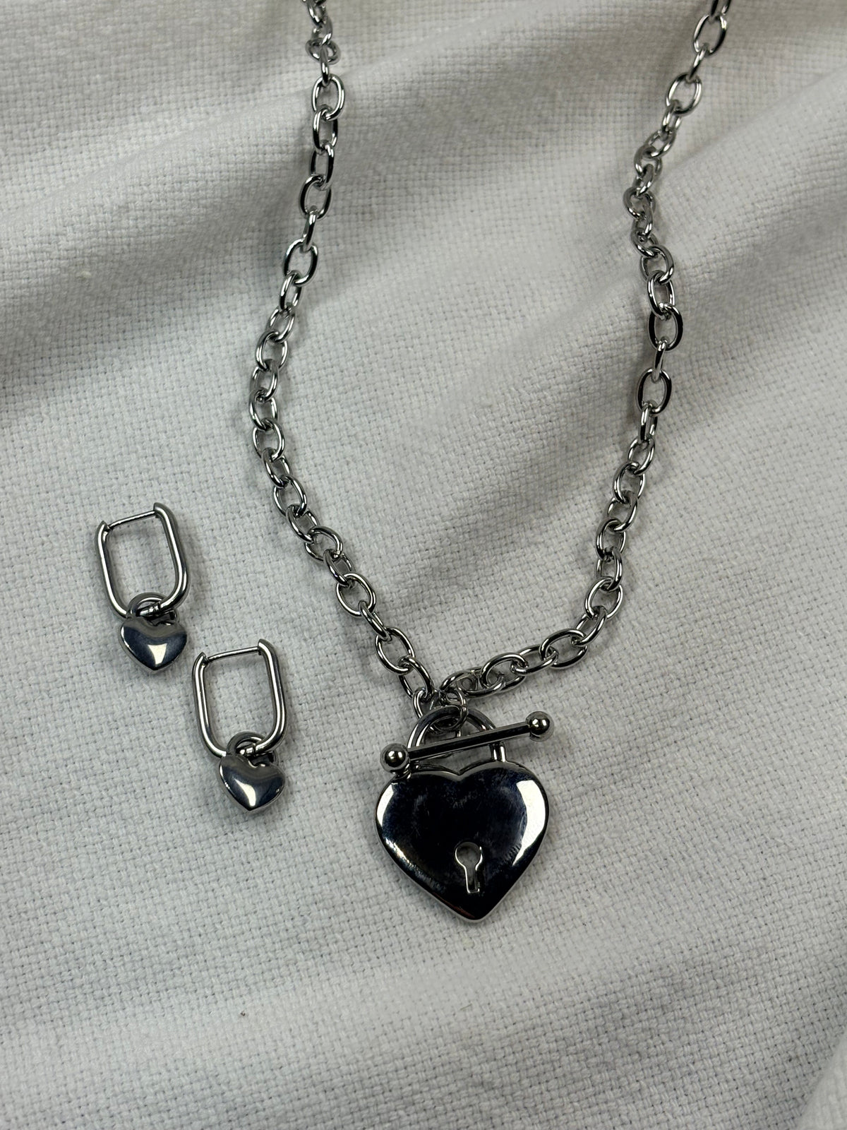 Silver necklace with heart pendant and heart hoop earrings