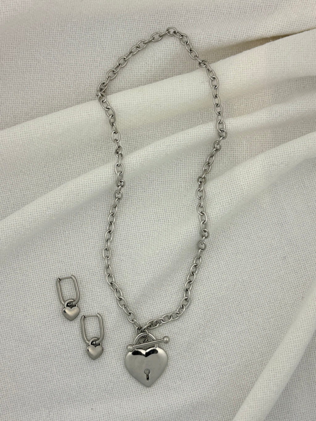 Silver necklace with heart pendant and heart hoop earrings