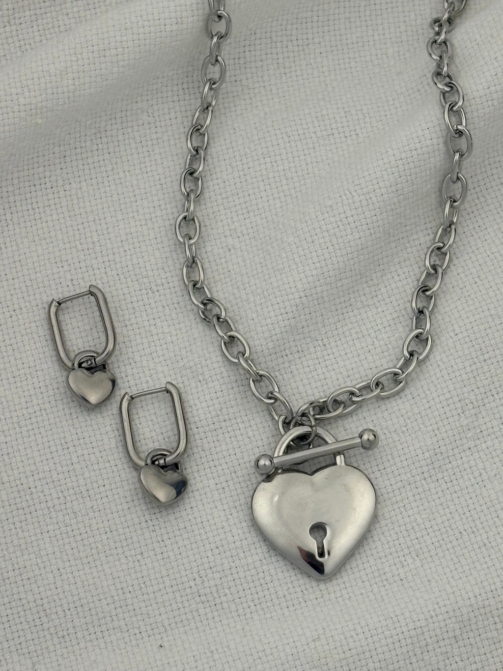Silver necklace with heart pendant and heart hoop earrings