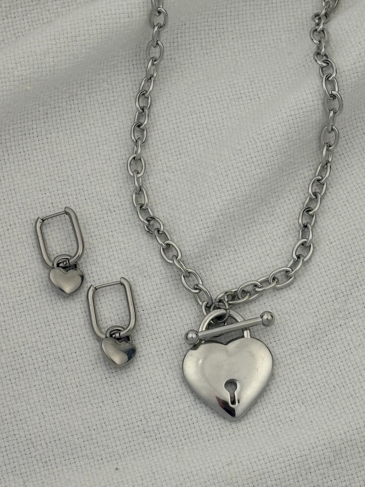 Silver necklace with heart pendant and heart hoop earrings